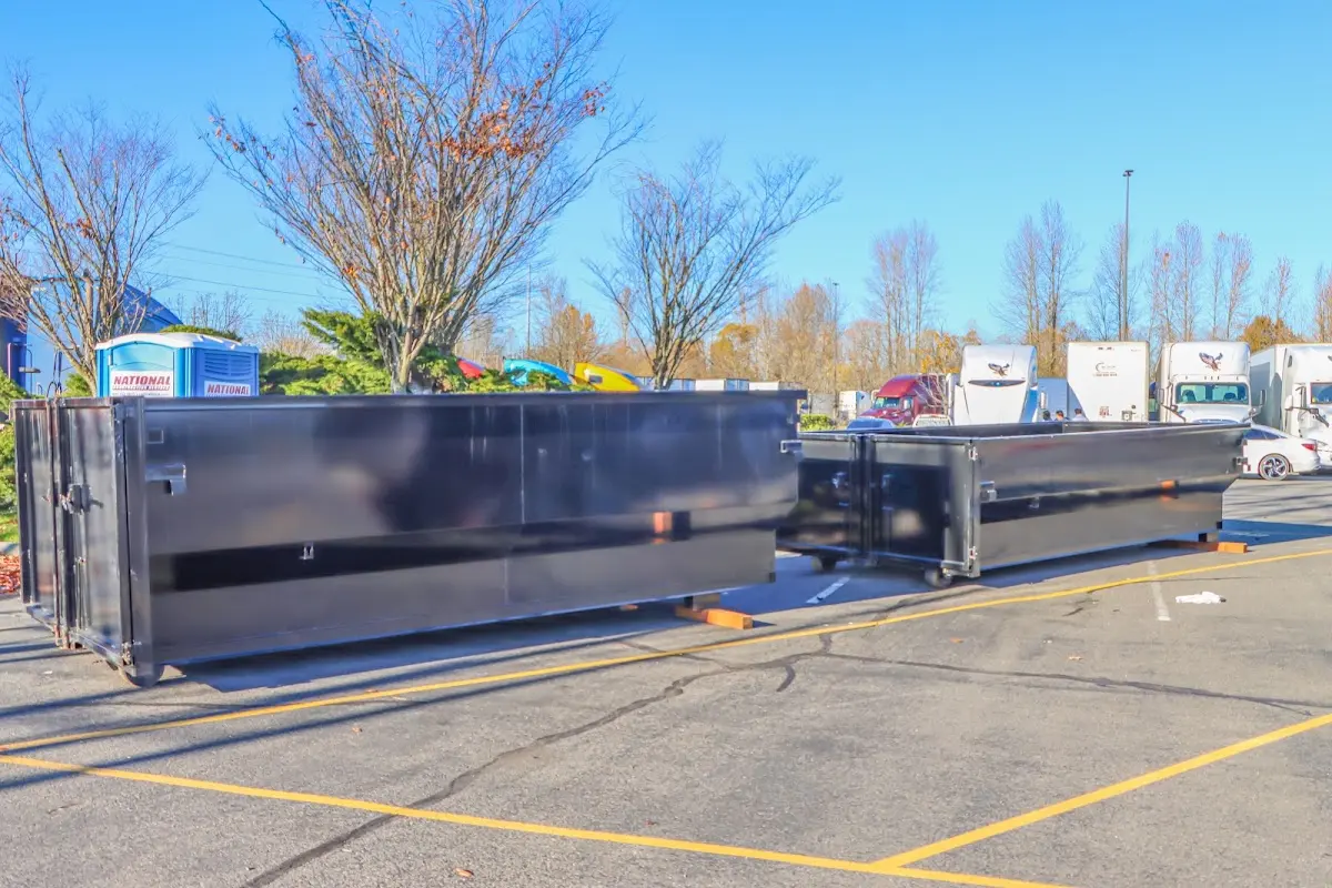 Professional dumpster rental service with roll-off container on residential driveway in Montvale